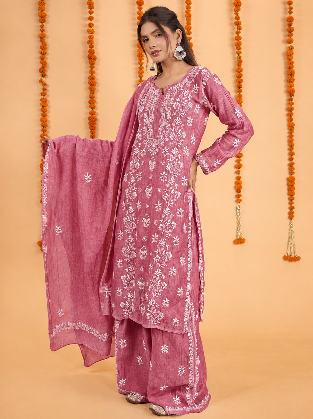 Model showcasing the Sofia Mul Chanderi kurta set with dupatta, highlighting leafy embroidery, decorative sleeve cuffs and embroidered borders along the wide-leg trousers.