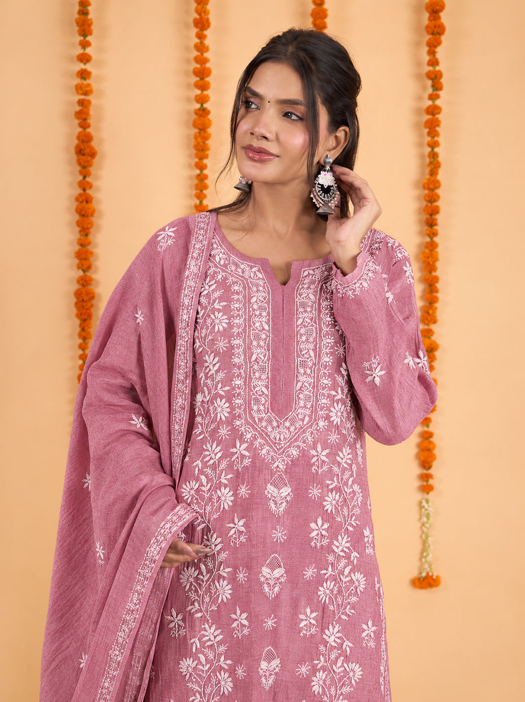 Sofia Mul Chanderi Chikankari kurta set with an intricately embroidered notched neckline, floral vine patterns across the front and coordinated wide-leg bottoms with scattered motifs.