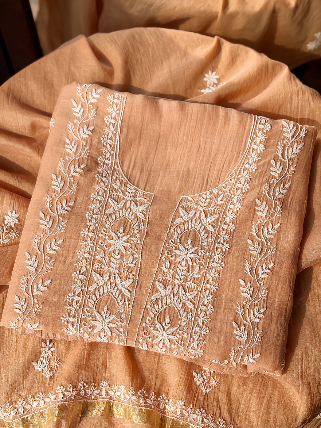 Mul Chanderi unstitched kurti piece with dupatta featuring handcrafted floral Chikankari embroidery displayed neatly for product showcase.