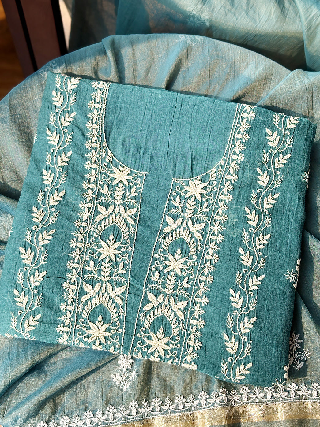 Unstitched Mul Chanderi kurti material with floral Chikankari threadwork displayed for online shopping presentation.