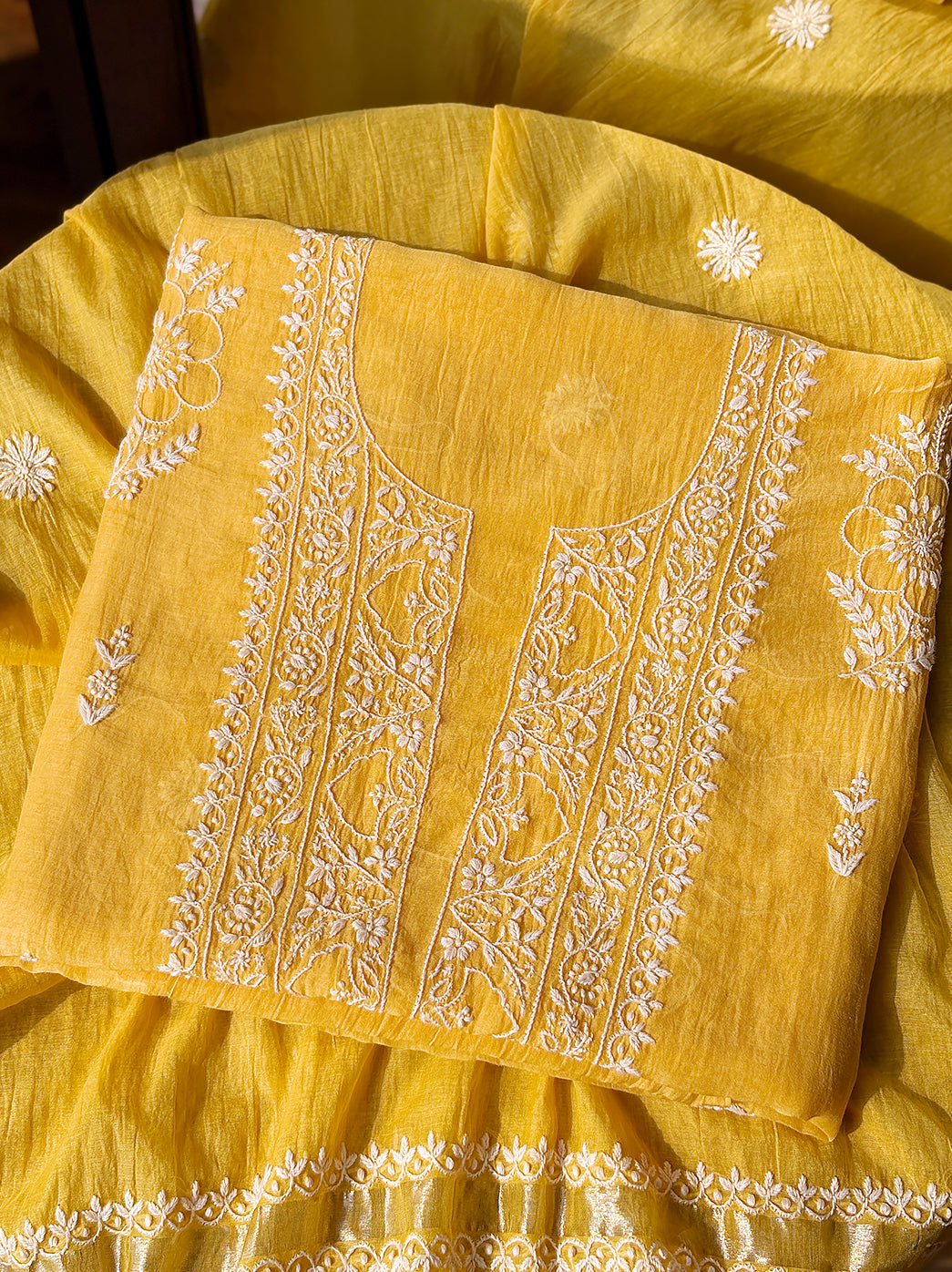 Mul Chanderi unstitched kurti piece with dupatta featuring handcrafted floral Chikankari embroidery displayed neatly for product showcase.