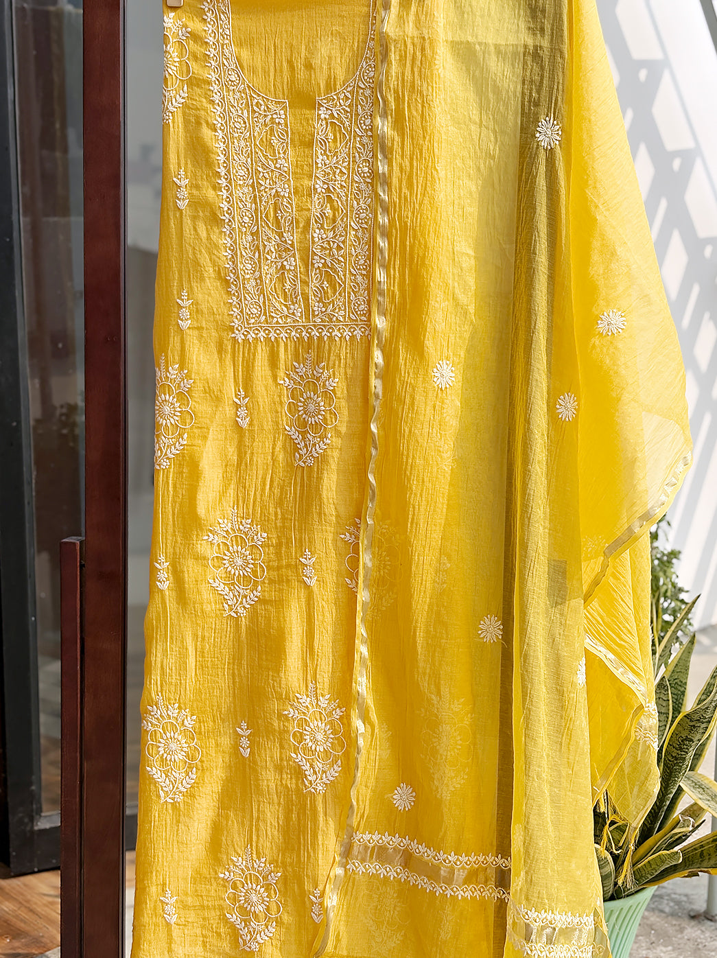 Mul Chanderi kurti piece with dupatta laid flat to highlight delicate hand-embroidered Chikankari floral designs and borders.
