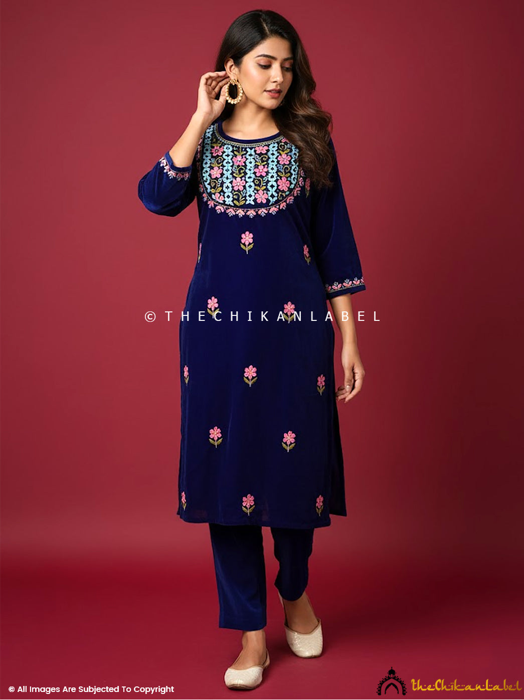 Ethnic velvet chikankari straight kurta ensemble with artisan embroidery photographed for luxury festive fashion.