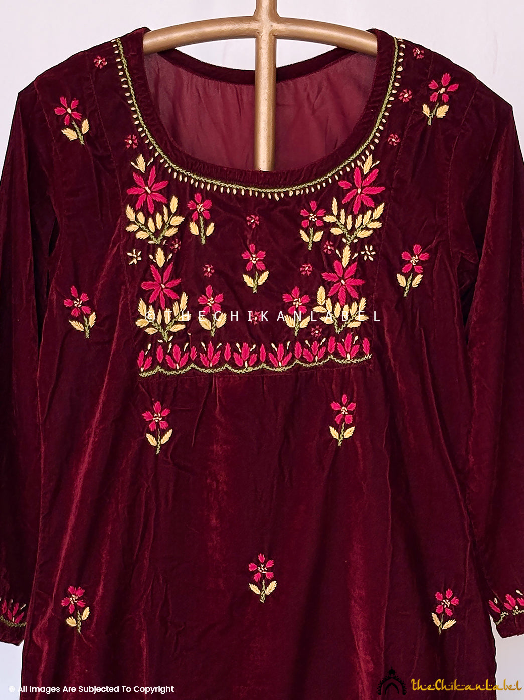 Handcrafted velvet chikankari kurta and pants set with intricate neckline detailing suitable for winter events and celebrations.