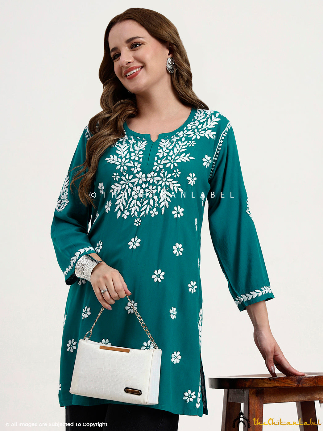 Designer women’s ethnic short top with delicate chikankari embroidery patterns.