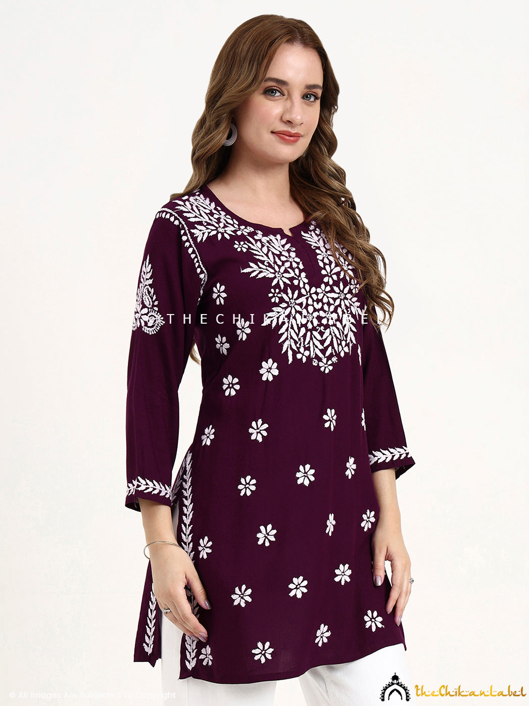 Hand-embroidered modal short kurti top featuring delicate chikankari motifs.