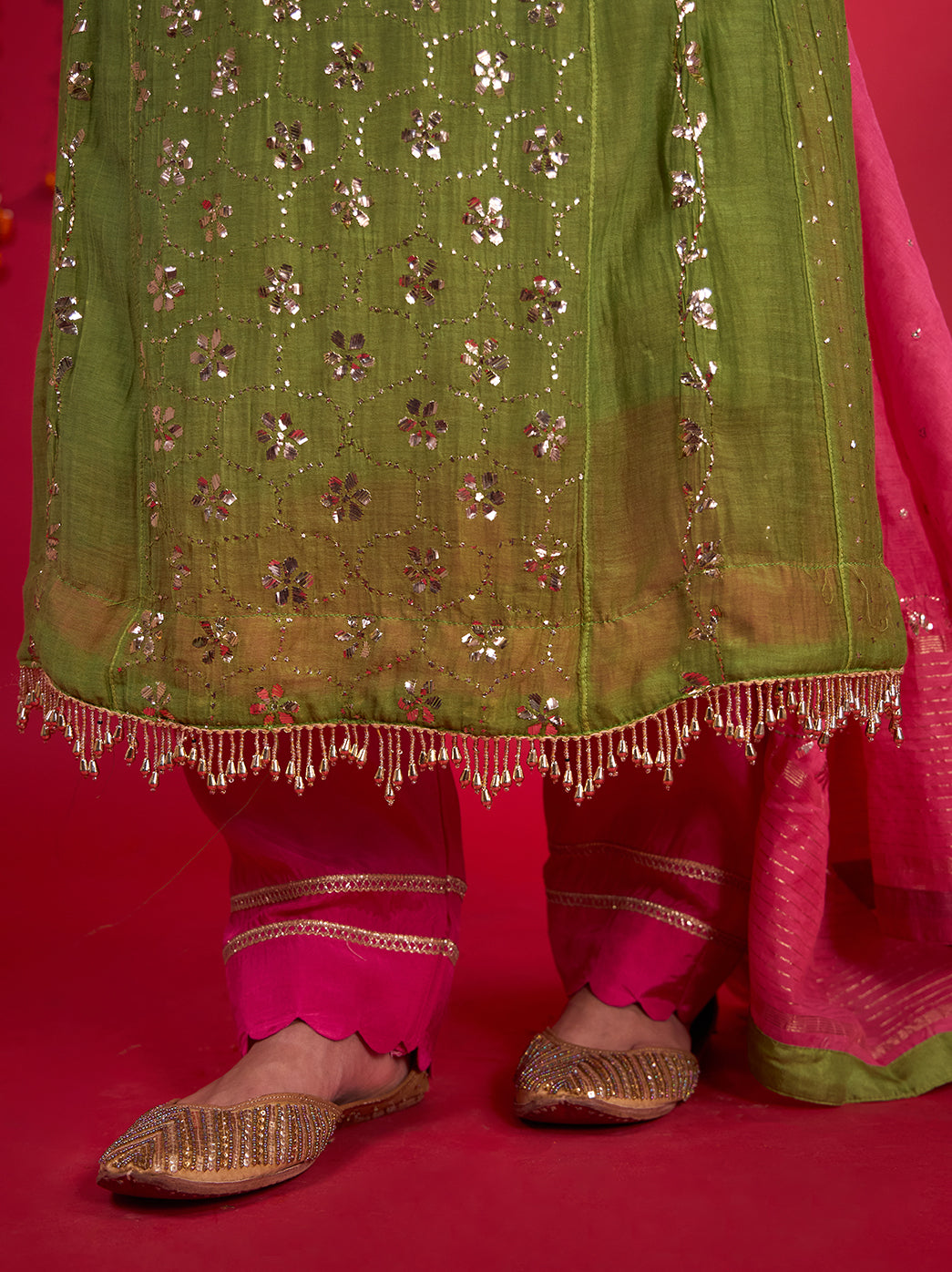 Model looking down while wearing the Tehzeeb Chikankari kurta set, showcasing the embroidered neckline and shimmering floral details running along the long kurta.