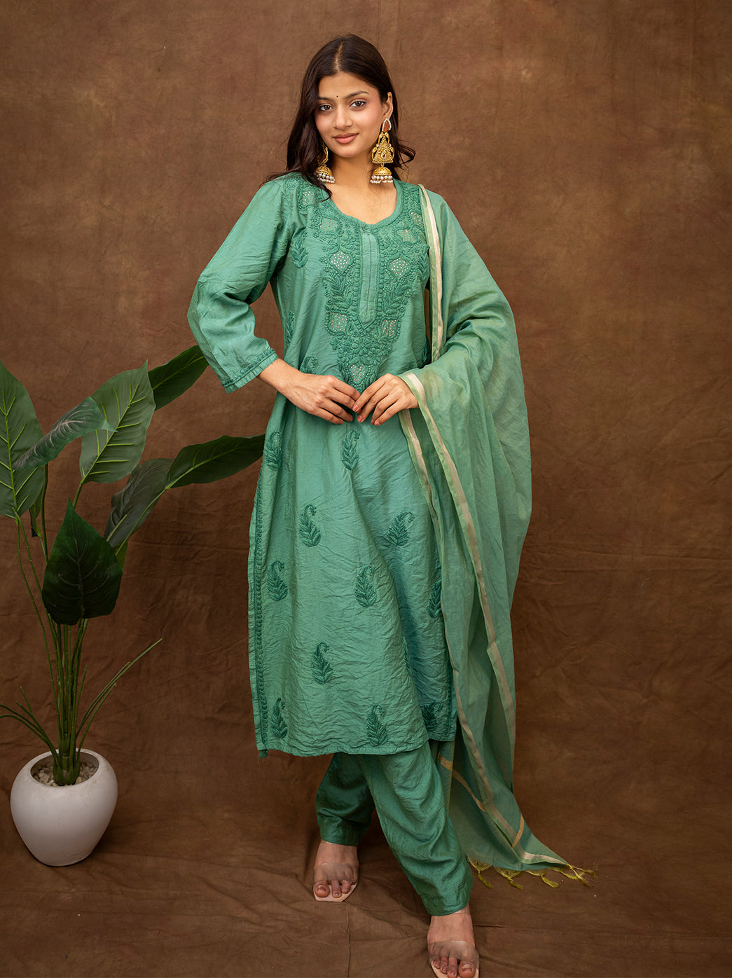 Model wearing a handcrafted chikankari kurta set with dupatta suitable for festivals and family functions