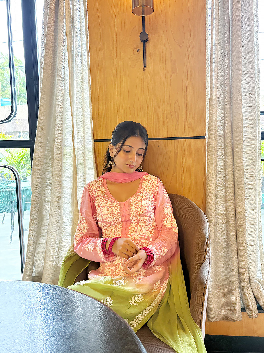 Woman modelling a comfortable regular wear Chikankari set with a long straight kurta, floral embroidery, coordinated bottoms and a lightweight dupatta.