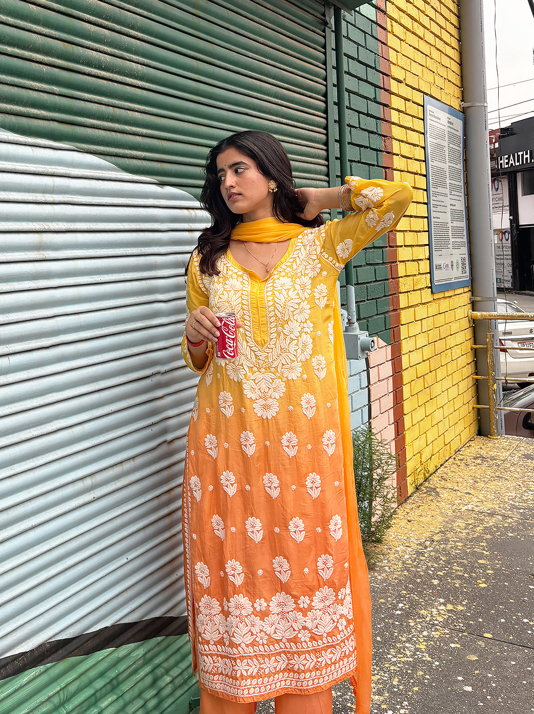 Elegant women’s Chikankari set designed with a rounded neckline, long sleeves, embroidered floral motifs, straight hemline and comfortable coordinated trousers.