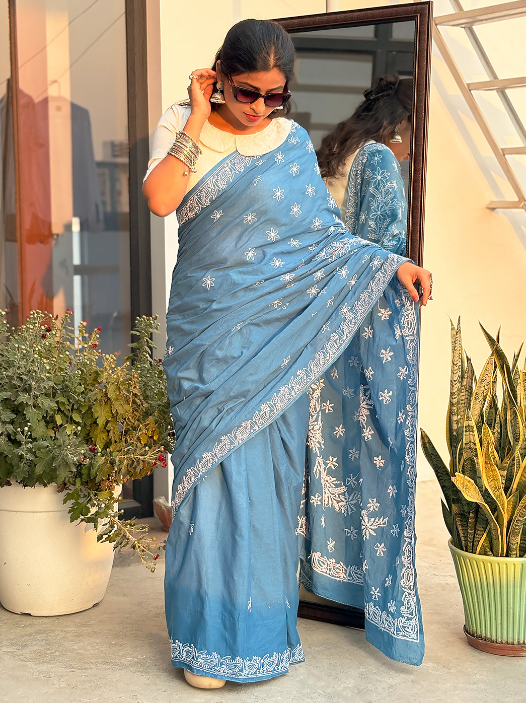 Handcrafted mulmul cotton saree displaying traditional Chikankari floral patterns, ideal for summer wear and everyday ethnic styling.