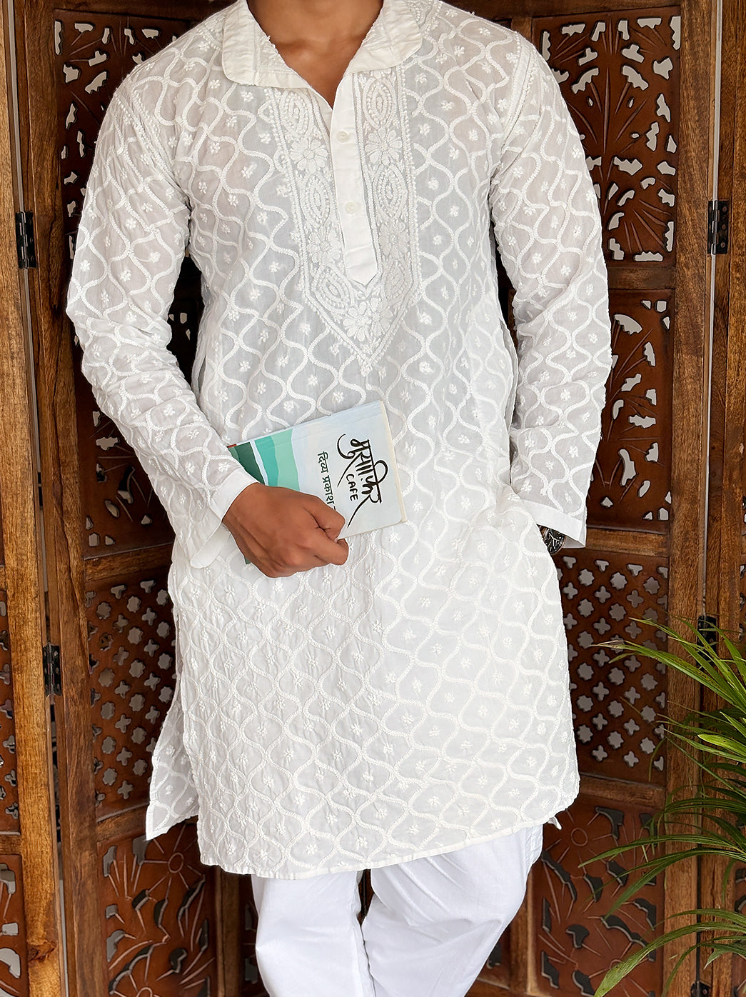 Male model wearing a cotton men’s straight kurta with detailed Chikankari embroidery, full sleeves, collared neckline and button placket.