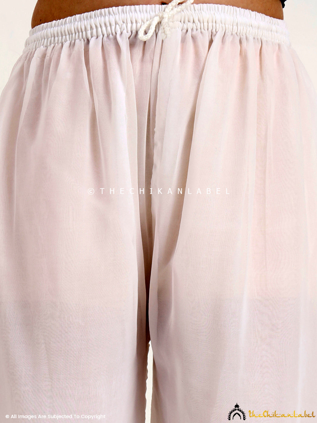 Trending chikankari sharara in georgette fabric designed with intricate hand embroidery and flared hem.