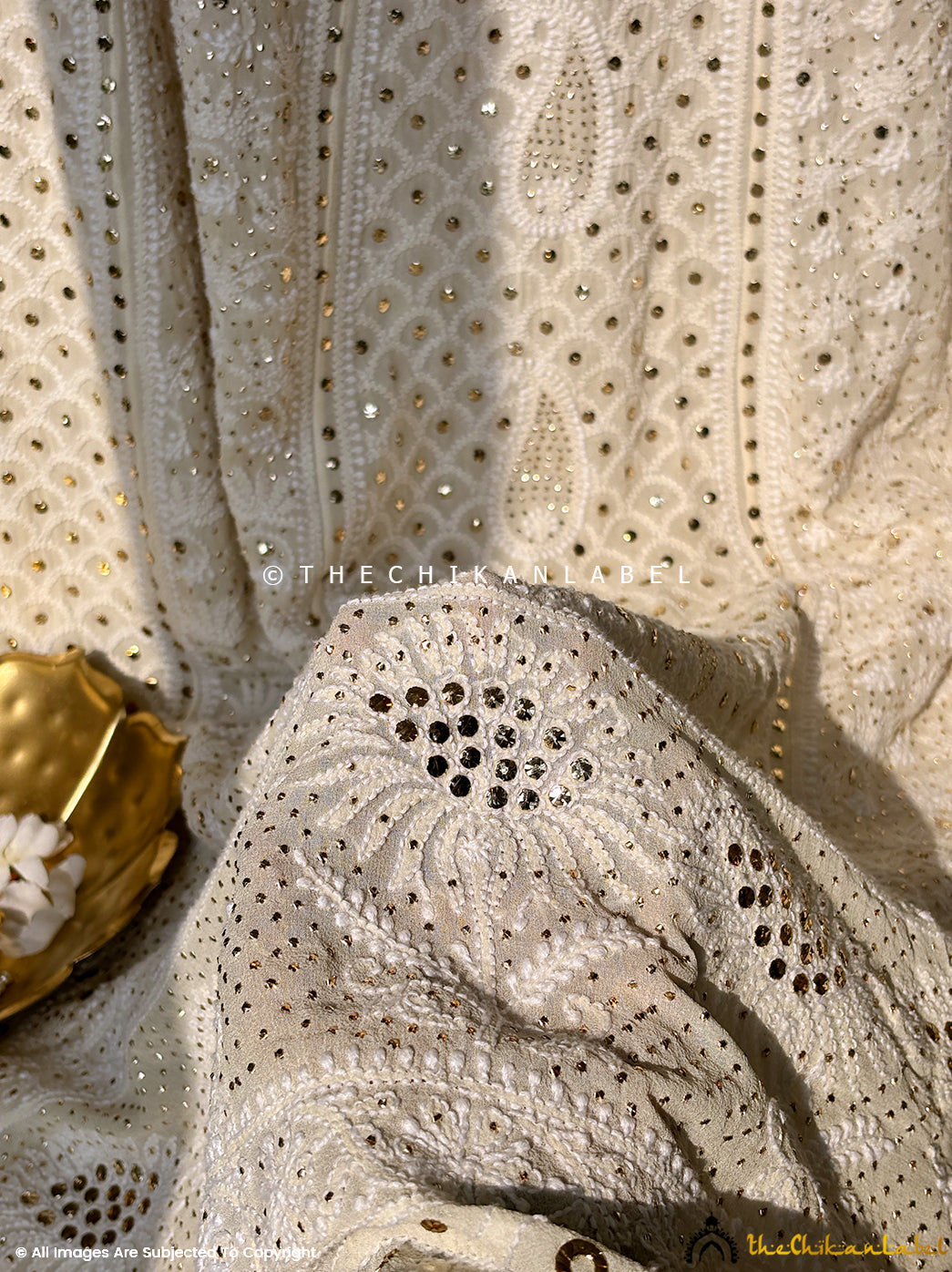 Artisanal georgette lehenga set showcasing traditional chikankari embroidery blended with luxury mukaish detailing.