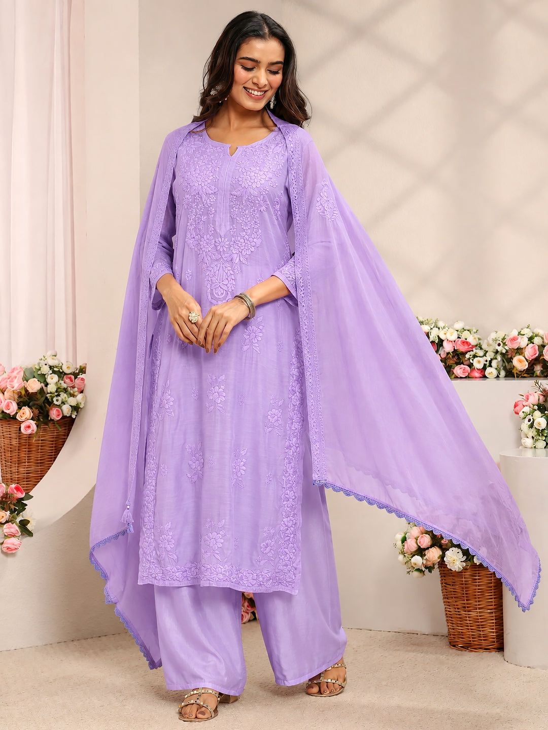 Traditional Chikankari muslin set featuring delicate floral embroidery on a straight-cut kurta paired with comfortable matching palazzo pants and a flowing dupatta.