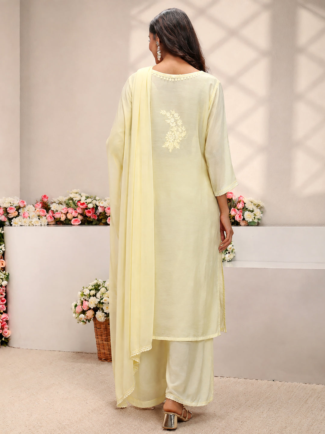 Elegant Lucknowi Chikankari kurta set for women crafted from soft muslin with intricate embroidered motifs, matching palazzo bottoms and a coordinated dupatta.