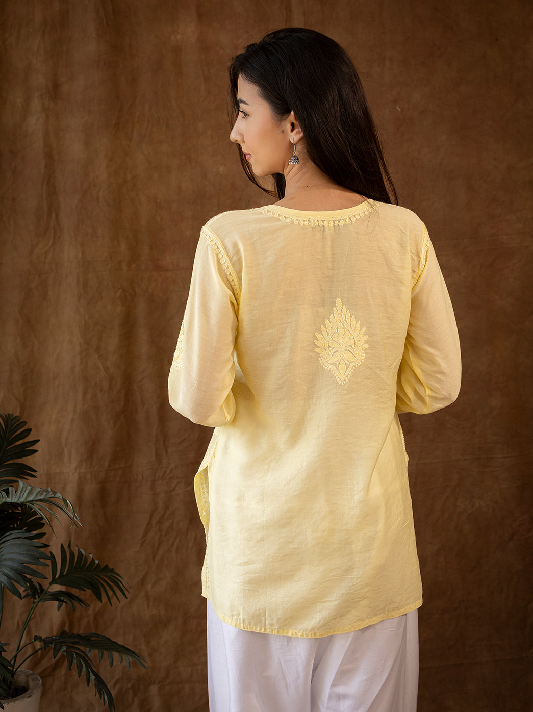Traditional chikankari kurti with intricate hand embroidery on the front and sleeves, styled with flowy farshi salwar for a regal look
