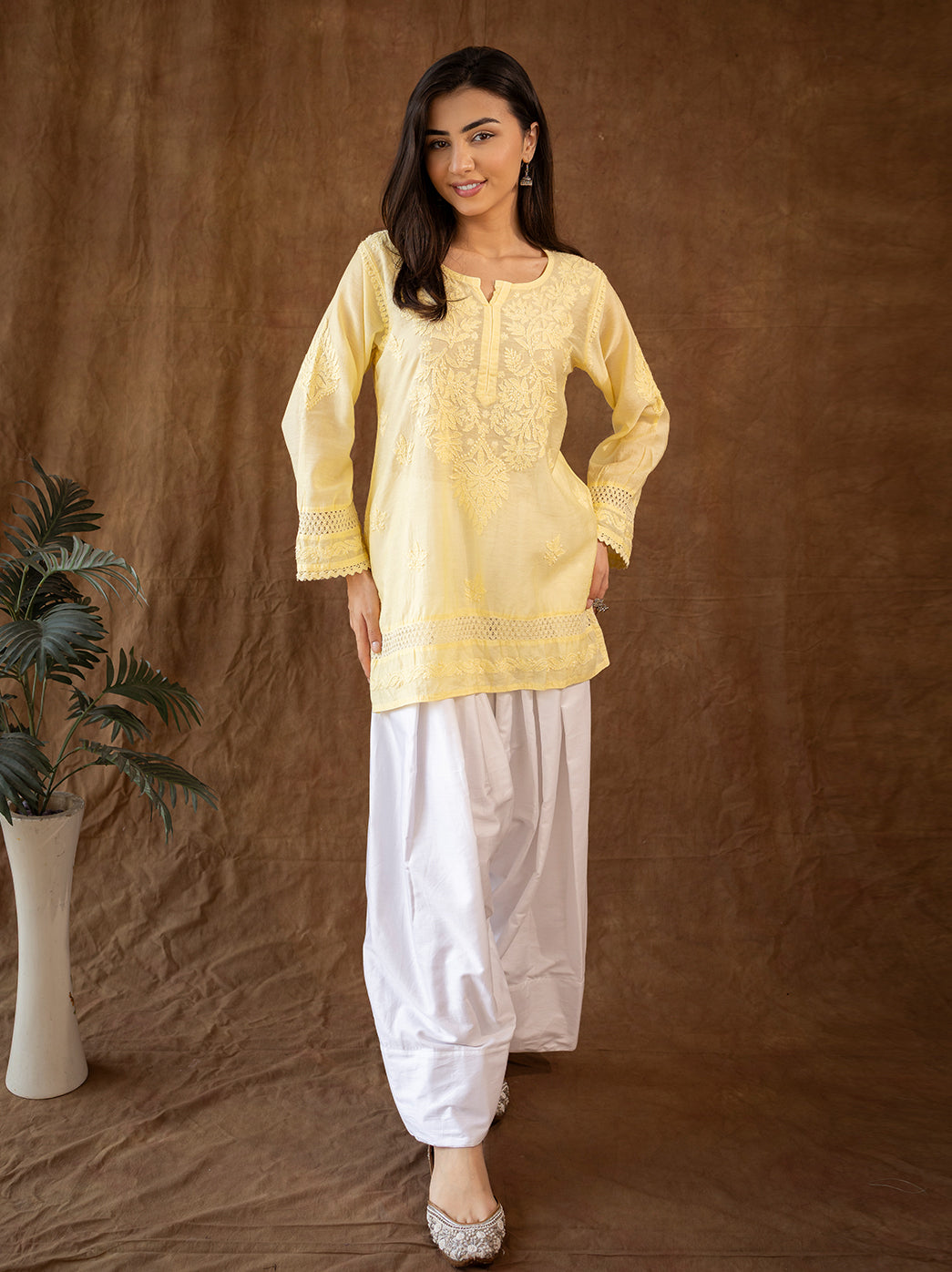 Ethnic chikankari kurti featuring detailed floral embroidery, paired with classic farshi salwar inspired by traditional Awadhi fashion