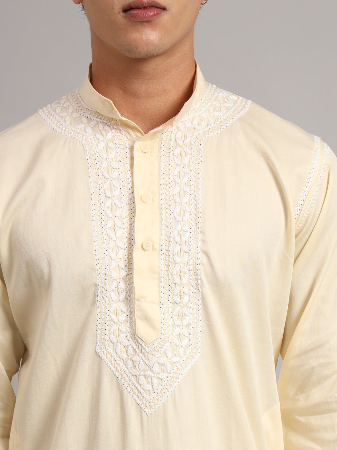 Men's Chikankari kurta from the Uman collection displayed in a full-length standing pose, highlighting the balanced placement of collar, chest and shoulder embroidery.