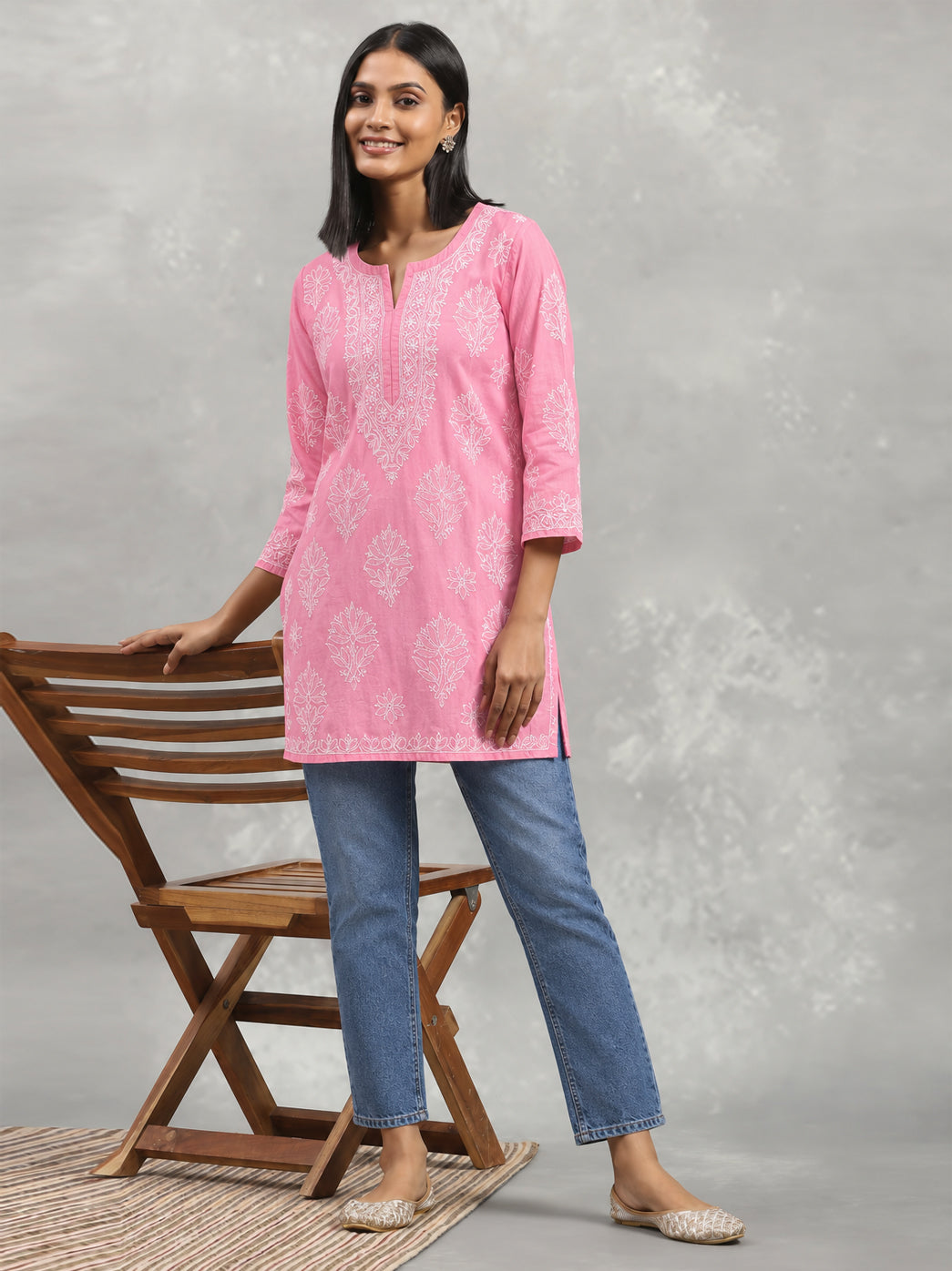 Ziva Cotton Short Kurti with detailed botanical embroidery around the chest, smaller scattered flowers and decorative edging at the sleeve openings.