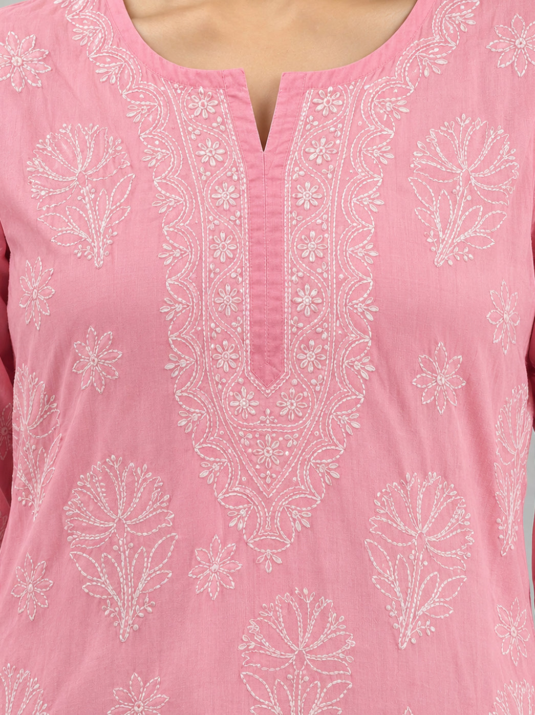 Ziva Cotton Short Kurti showing a mix of branching floral motifs and small flower shapes, with embroidery framing the neckline and finishing the hem.