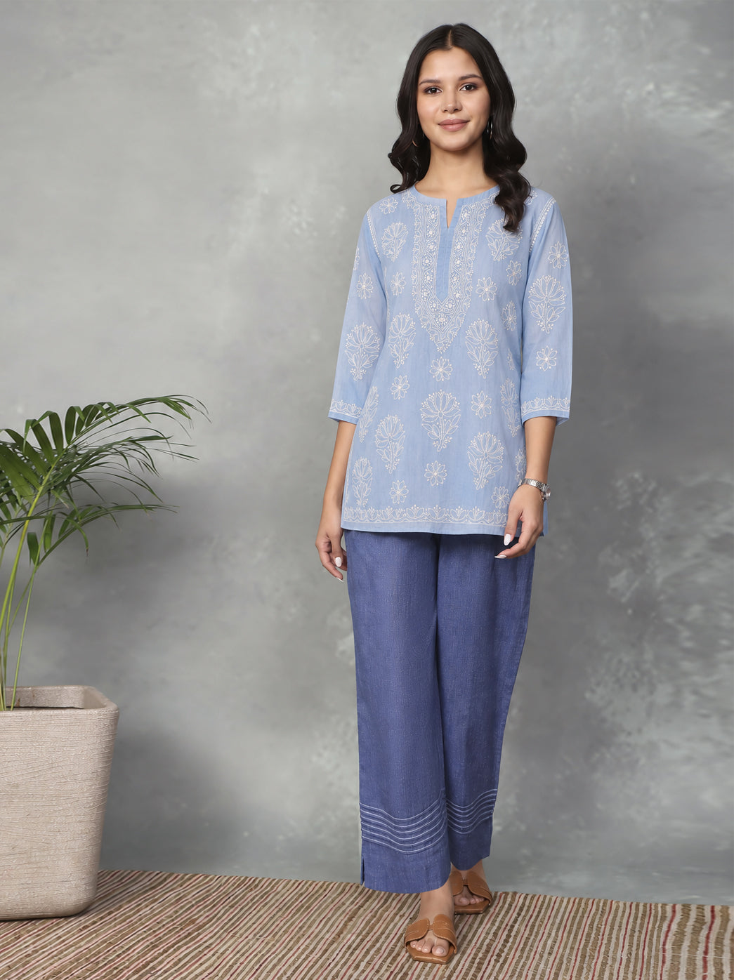 Front-facing Ziva Cotton Short Kurti with a straight hem, small side openings and an embroidered floral border following the lower edge.
