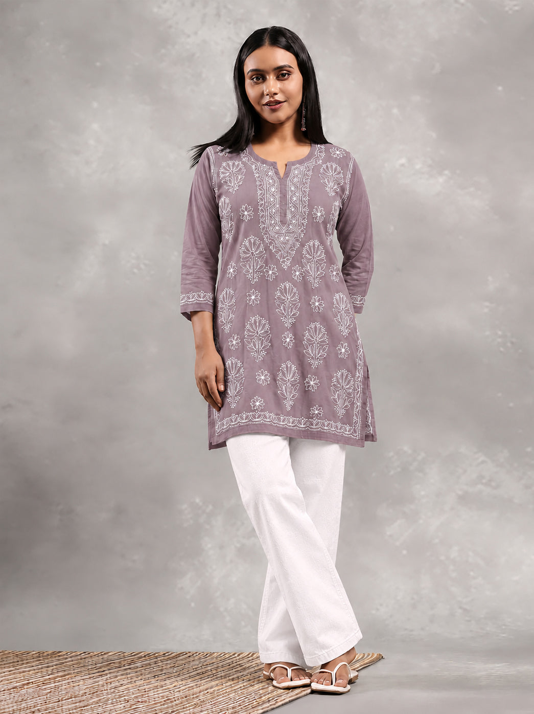 Full front view of the Ziva Cotton Short Kurti, showing the placement of floral Chikankari motifs from the shoulders to the embroidered lower border.