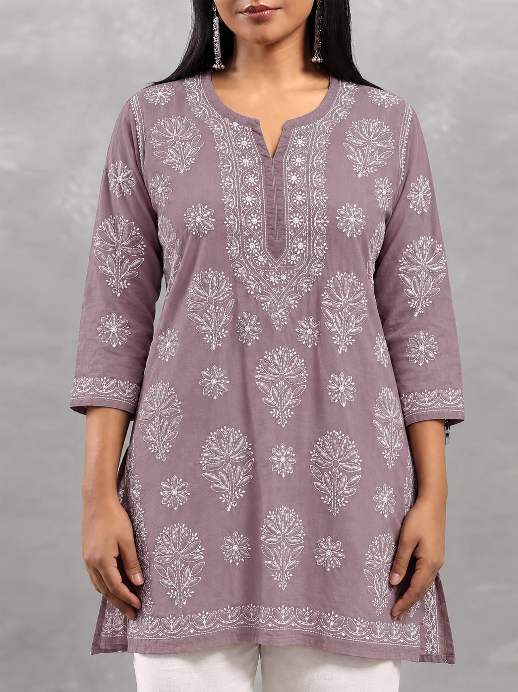 Ziva Cotton Short Kurti with detailed botanical embroidery around the chest, smaller scattered flowers and decorative edging at the sleeve openings.