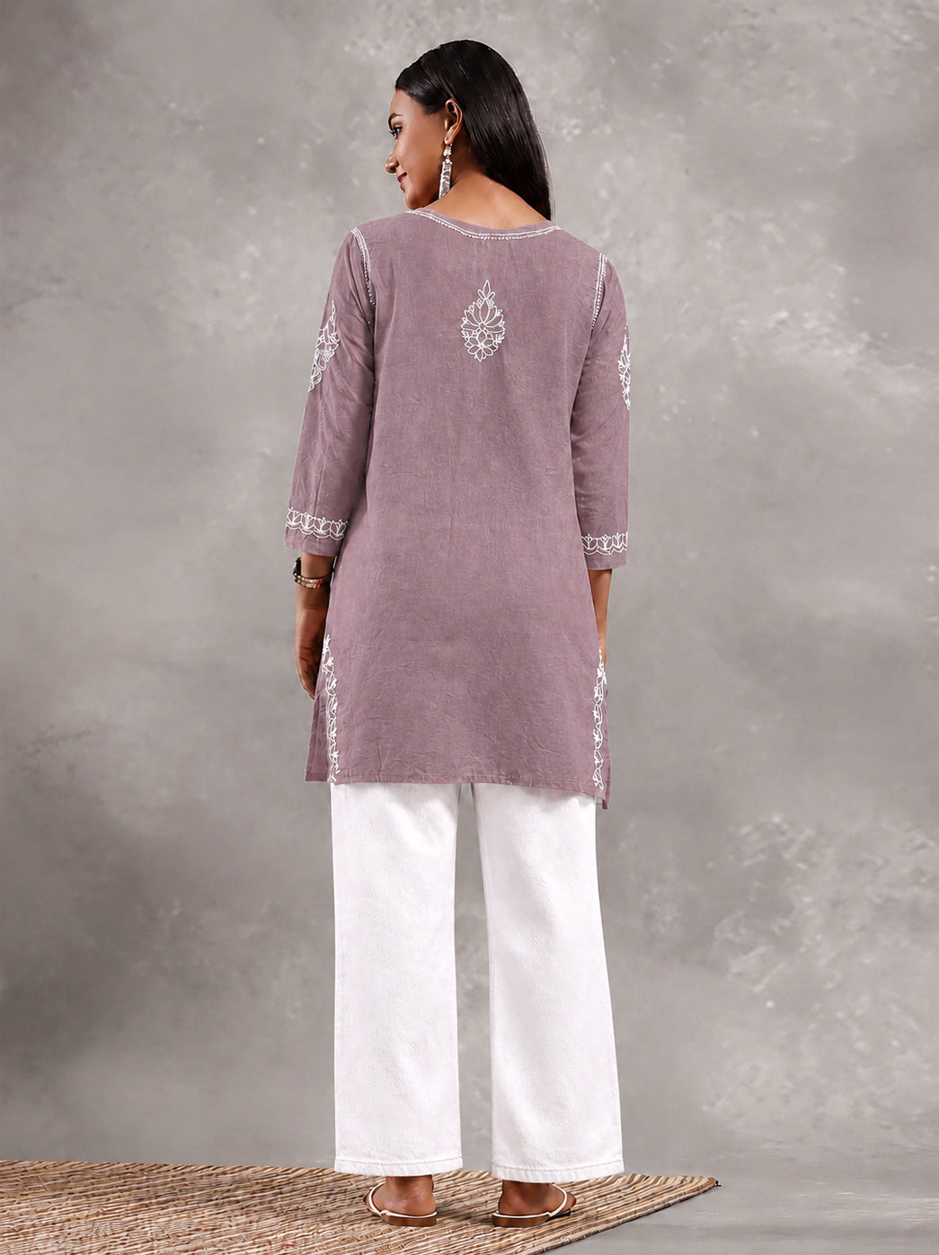 Ziva Cotton Short Kurti showing a mix of branching floral motifs and small flower shapes, with embroidery framing the neckline and finishing the hem.