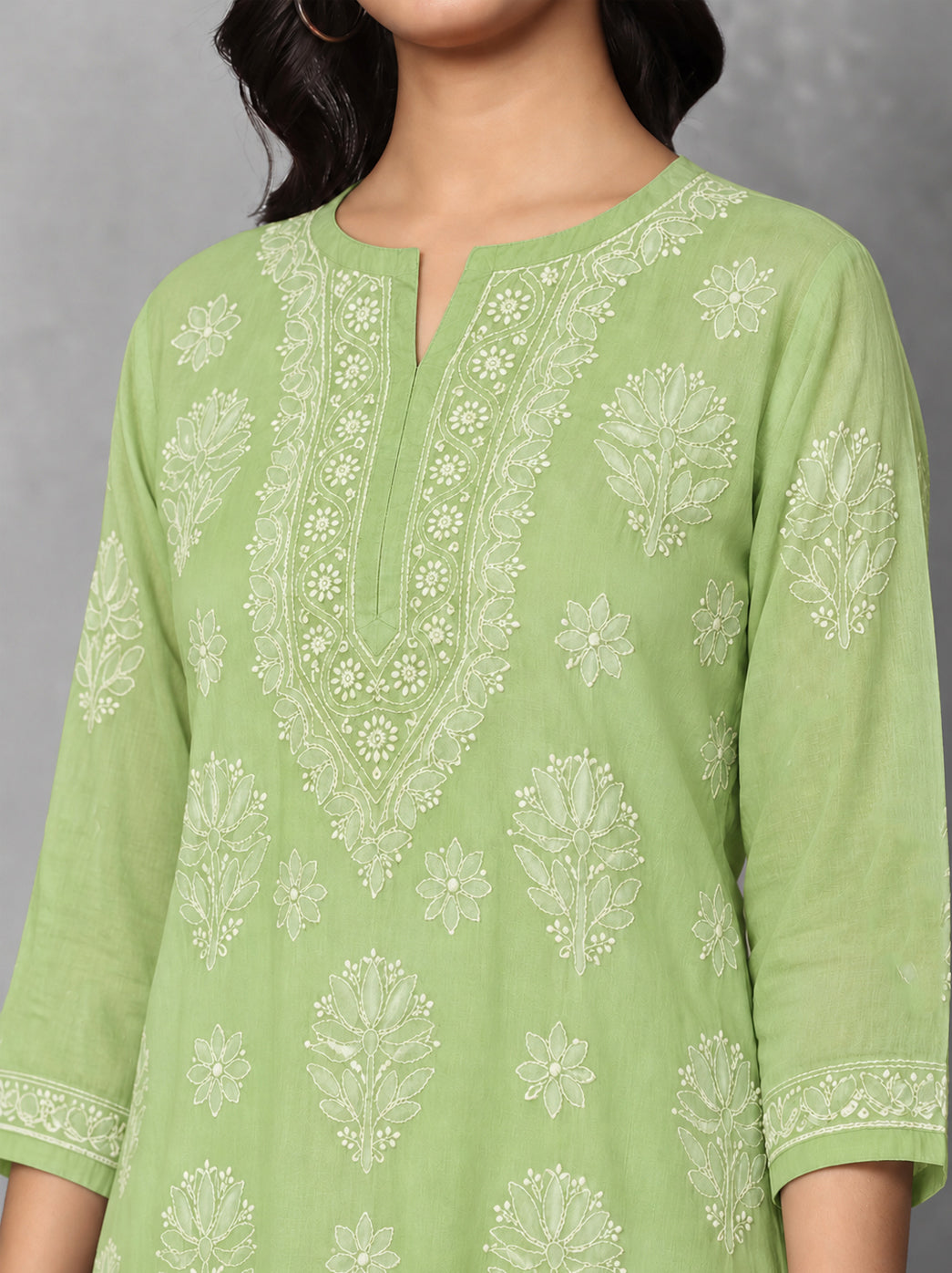 Ziva Cotton Short Kurti displayed from the front, highlighting the rounded neckline with a central notch and intricate floral Chikankari surrounding the opening.