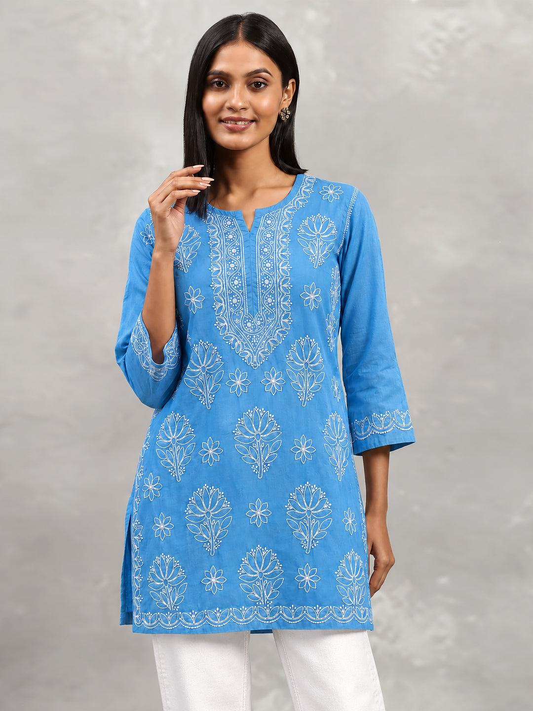 Ziva Cotton Short Kurti featuring floral Chikankari embroidery across the front, a notched round neckline and three-quarter sleeves with embroidered edges.