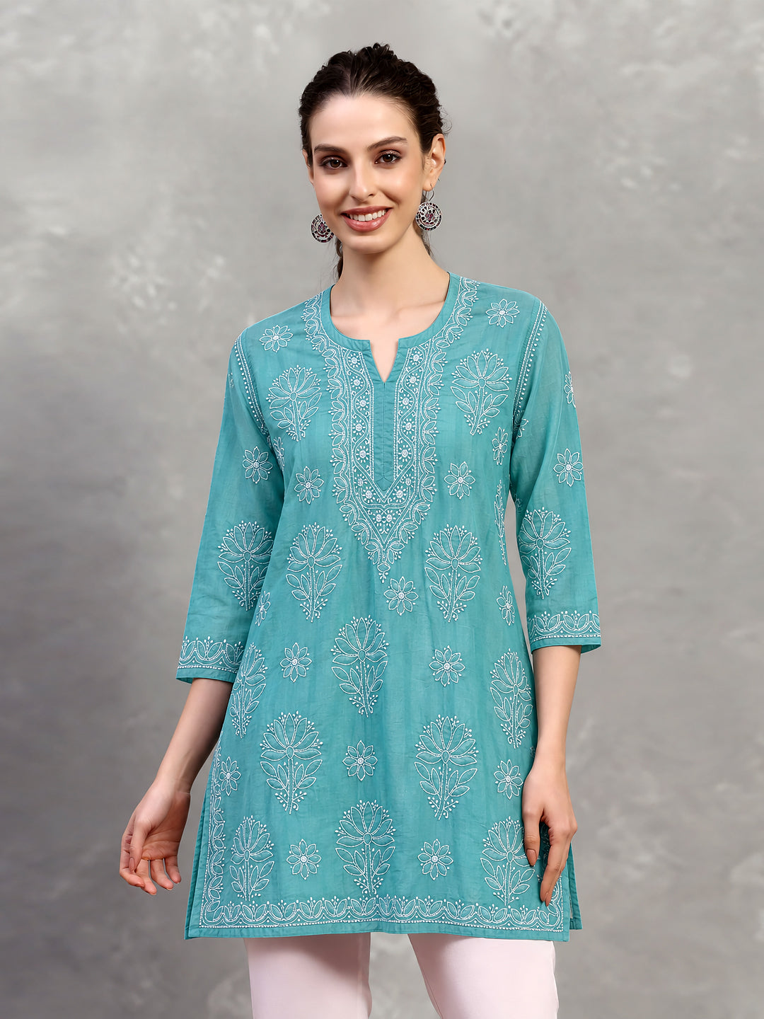 Ziva Cotton Short Kurti displayed from the front, highlighting the rounded neckline with a central notch and intricate floral Chikankari surrounding the opening.