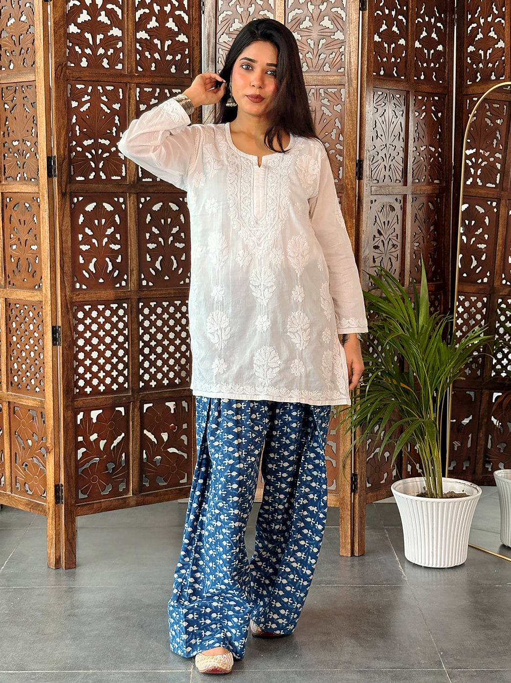 Ziva Cotton Short Kurti with detailed botanical embroidery around the chest, smaller scattered flowers and decorative edging at the sleeve openings.