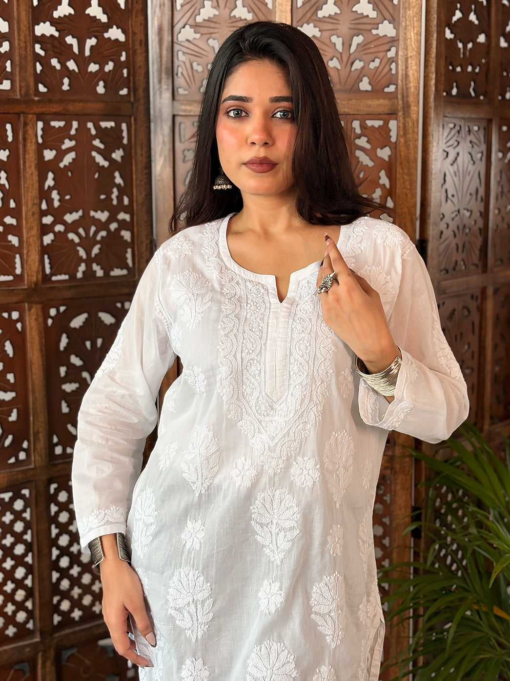 Ziva Cotton Short Kurti showing a mix of branching floral motifs and small flower shapes, with embroidery framing the neckline and finishing the hem.