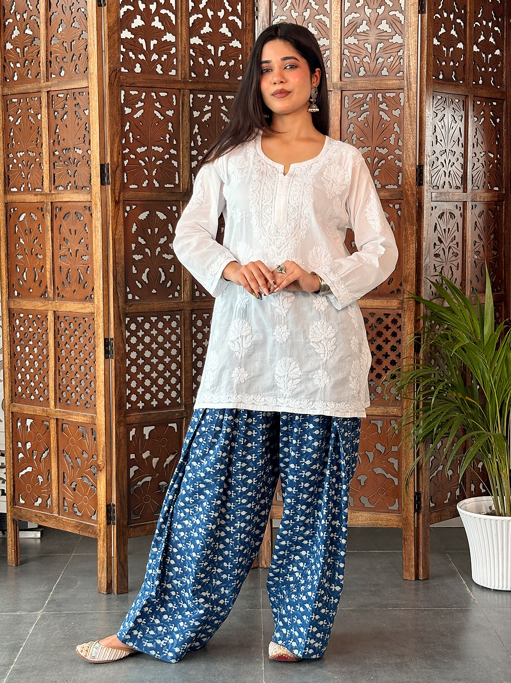 Cotton short kurti from The Chikan Label featuring a rounded neck opening, a narrow front notch and a long ornamental Chikankari neckline design.