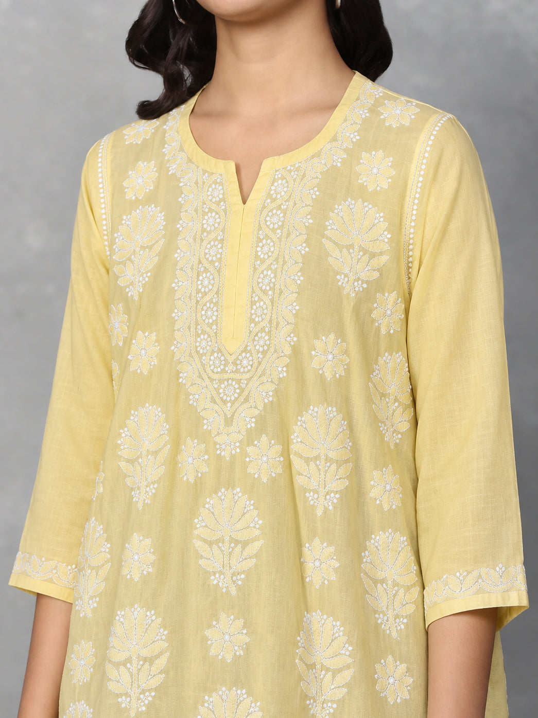 Ziva Cotton Short Kurti displayed from the front, highlighting the rounded neckline with a central notch and intricate floral Chikankari surrounding the opening.